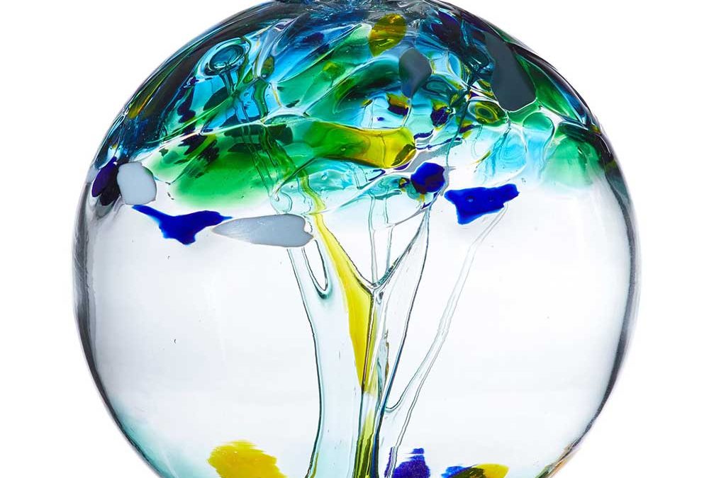 Hand blown glass ball with swirls of blues, greens and yellows